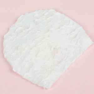 Soft white knit turban hat for newborn babies with ruffled texture on pink background