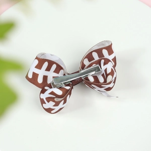 Detail of 3-inch baseball print hair bow with silver alligator clip for children