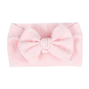 Elastic baby headband with large bow in soft light pink ribbed knit fabric