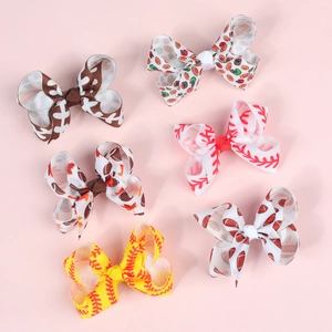 Detailed view of 3-inch sports-themed grosgrain ribbon hair bows with baseball patterns