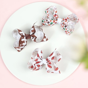 Detailed macro view of 3-inch baseball printed grosgrain ribbon bows on alligator clips