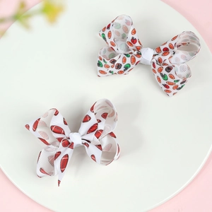 Detail of 3-inch grosgrain ribbon bow hair clips with American football themed prints
