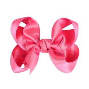 Detailansicht einer rosaroten Satin-Haarschleife mit Seidenglanz und sauberem Knoten