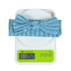 Blue striped knit baby headband with rabbit bow detail weighing 20.2g on scale