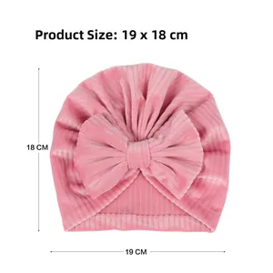 Pink corduroy baby turban hat with large bow detail and 19x18cm size specifications