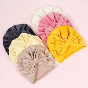 Set of six colorful ribbed knit baby turban hats featuring large bow decorative elements