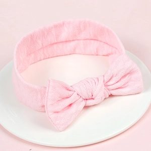 Pink elastic baby headband with textured knit fabric and cute rabbit ear bow knot