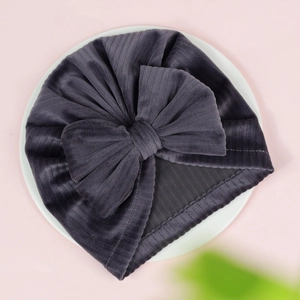 Detail of dark grey corduroy baby turban hat with a large textured bow feature