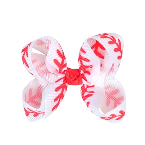 Detail of 3-inch white grosgrain ribbon hair bow with baseball stitching print and red center