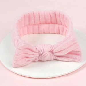 Pink ribbed knit newborn headband featuring a soft elastic rabbit ear bow for baby girls