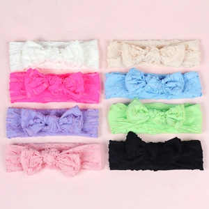 Detail of 8 colorful elastic baby headbands with large bows and textured rib fabric
