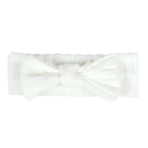 Detail of white newborn headband showing vertical ribbed texture and a large soft bow