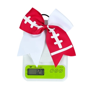 Detail shot of a red and white rugby-style bow on a scale showing 12.7g weight