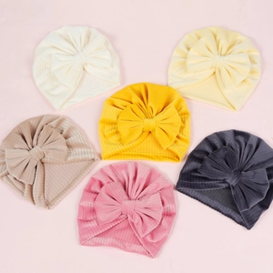 Detail of ribbed knit baby turban hats with large bows in six soft pastel colors