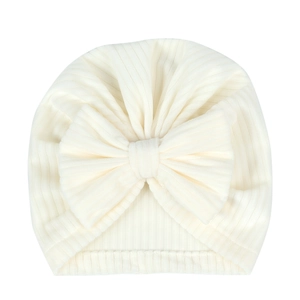 Close-up of baby turban hat showing ribbed fabric texture and large bow detail