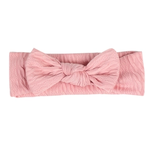 Bandeau bébé rose en tricot torsadé avec grand nœud et tissu doux élastique
