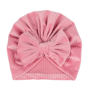 Pink ribbed velvet baby turban hat with a large bow for newborns and infants