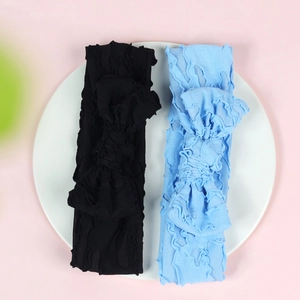 Detail of high-elastic knit baby headbands in black and light blue with bow texture