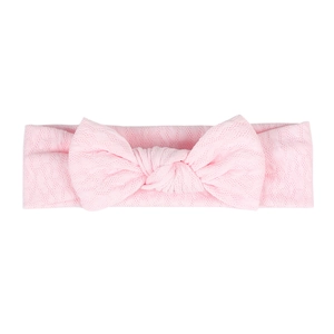 Detail of baby headband featuring soft pink diamond knit texture and large bow