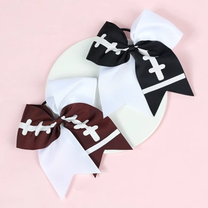 Detail of large grosgrain football print cheer bows in black, brown and white colors