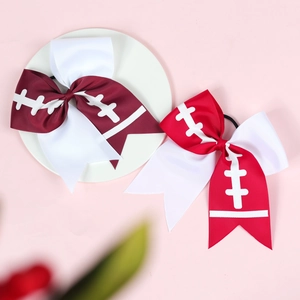 Detail of rugby-themed hair bows with white stitching patterns on premium grosgrain ribbon