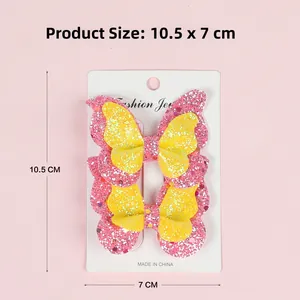 Close-up of glitter hair clips set for girls in pink and yellow on paper card