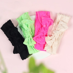 Set of four elastic bow headbands in black, mint, rose, and cream for baby girls