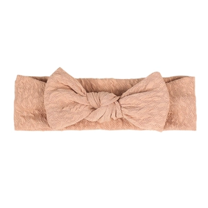 Elastic nude pink knitted baby headband featuring a stylish rabbit ear bow decoration