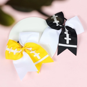 Detail of rugby-themed cheerleader hair bows with football stitching patterns