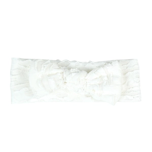 Detailed view of white baby headband with hollow texture and a large decorative bow