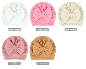 Flat lay showing five colors of ribbed baby turban hats with large bows in detail