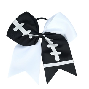 Detail of a black and white cheerleader hair bow with football stitching pattern
