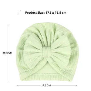 Detailed view of baby ribbed knit turban hat in mint green with product size dimensions