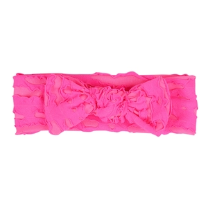 Detailed close-up of bright pink elastic baby headband with textured knit bow detail