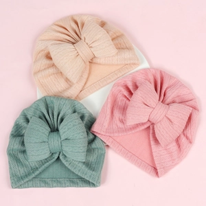 Detailed knit texture of soft newborn baby turbans with large stuffed bows in three colors