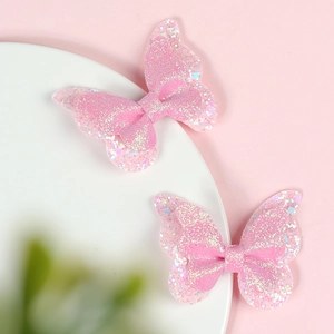 Detail of pink glitter butterfly hair clips with colorful sequins for girls and children