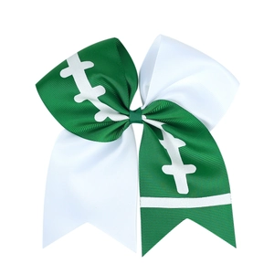 Close-up of grosgrain ribbon cheer bow with green and white football print patterns
