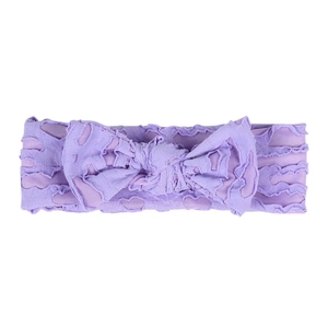 Detail of purple infant headband with hollow heart texture and soft knit bow design