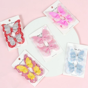 Detail view of five pairs of glitter butterfly hair clips on display cards