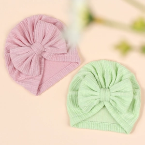 Detail showing pink and mint green waffle knit baby turbans with large soft bows