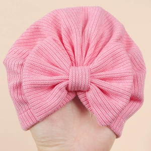 Close-up of pink baby turban hat showing soft ribbed knit texture and large bow detail