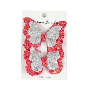 Detail of red and silver layered glitter butterfly hair clips on display card