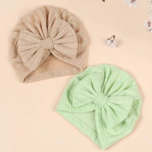 Two-pack soft knit baby turban hats with large bows in beige and mint green colors