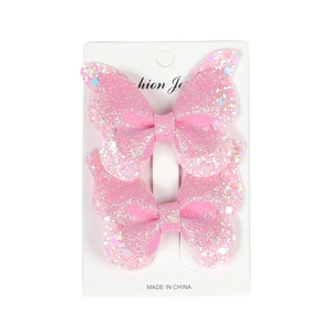 Close-up of pink glitter double-layered butterfly hair clips set on a display card