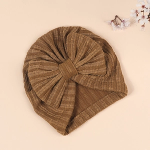 Detail of baby turban hat with a large bow and vertical ribbed texture in dark brown