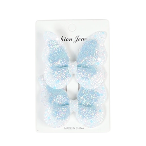 Sparkly light blue double-layered butterfly hair clips with sequins on a white display card