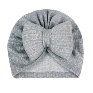 Close-up of grey knit cotton baby turban hat with a large decorative soft bow detail