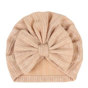Macro detail of breathable ribbed cotton baby turban hat with a large decorative bow