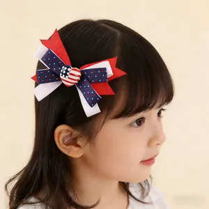 Detailed close-up of a patriotic double-layered bow hair clip with a red heart on a young girl