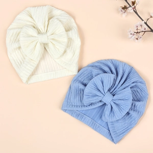 Two pack soft ribbed knit baby turban hats with large bows in white and blue colors